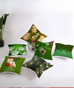 Close-up of six green and gold Christmas pillow covers with festive digital prints
