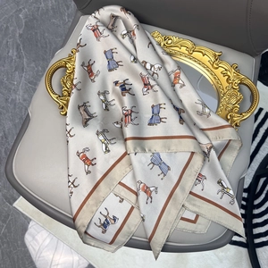 Macro view of vintage equestrian print scarf with colorful horse patterns and silk texture