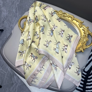 Satin silk square scarf with vintage horse print on elegant gold display tray