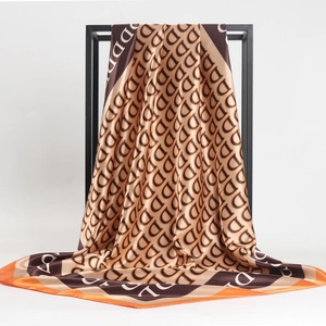 90cm satin square scarf with repeating D-print pattern in brown, gold and orange trim