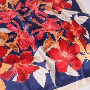 Luxurious satin silk scarf with large red hibiscus floral prints on a deep blue background