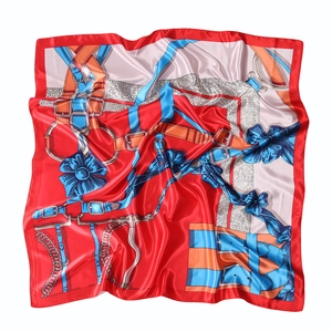 Detail of red border silk scarf with equestrian horse bit print and satin texture