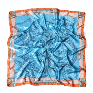 Macro detail of sky blue satin scarf featuring vintage equestrian motifs and orange border