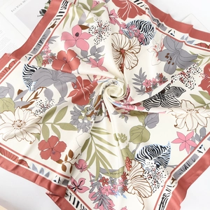 Detail of 90cm silk satin scarf featuring tropical floral prints and zebra patterns