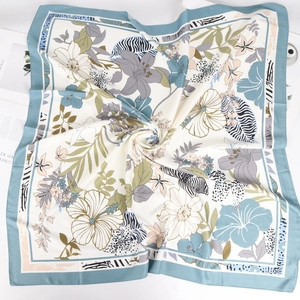 Detail of 90cm twill satin square scarf showing floral and zebra patterns with soft drapes