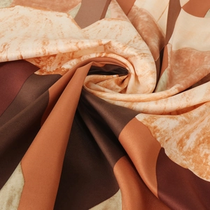 Silk-like scarf with geometric marble art pattern in deep brown and orange tones