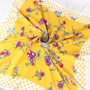 Silk square scarf with floral print and polka dot border shown in artistic twist