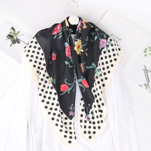 Silk-like fashion scarf with floral print and black and white polka dot border pattern