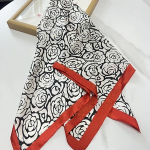 Carré de soie satinée 70cm à motif camélia avec bordure rouge sur fond de marbre blanc