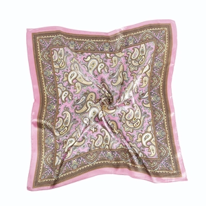 Detail of pink paisley satin silk scarf showing smooth texture and fine edge stitching