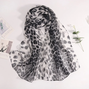 Detailed close-up of lightweight georgette scarf featuring black and white leopard print
