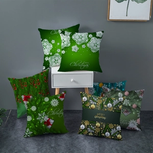 Green Christmas peach skin pillow covers featuring snowflakes and Merry Christmas prints