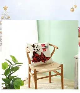 Detail of Christmas dog print on beige linen pillowcase with Ho Ho Ho text design