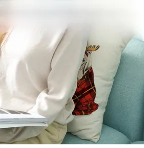 Nordic Christmas reindeer pillow cover featuring a red scarf on a blue sofa