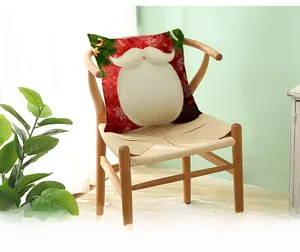 Detail of red Christmas pillowcase with Santa beard pattern on a wooden armchair