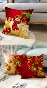 Cozy home setting with red and gold Christmas pillow covers featuring snowmen and ornaments