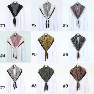 Detailed selection of houndstooth and leopard print scarves with metal rings