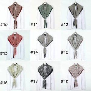 Nine pleated leopard and paisley cotton linen scarves displayed with gold buckle rings