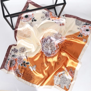 Elegant 90cm floral silk scarf with cream and orange prints on a grey background