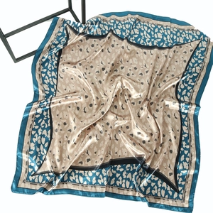 Peacock blue satin square scarf with leopard print and smooth glossy silk texture