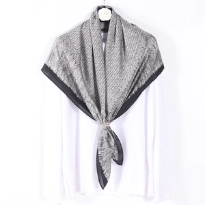 Elegant 90cm black and white monogram printed silk satin square scarf displayed on a white shirt