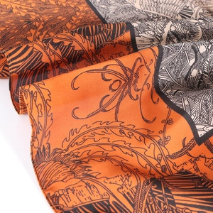 Elegant 90x90cm orange and cream floral silk scarf with artistic scroll leaf patterns