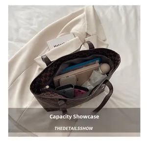 Macro view of a brown tote bag interior showing large capacity for iPad and essentials