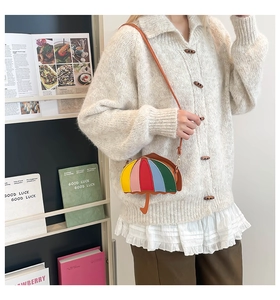 Detail of unique rainbow umbrella-shaped crossbody bag with creative colorful patchwork