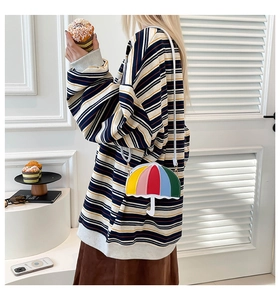 Detail of creative umbrella-shaped crossbody bag with colorful vertical stripes