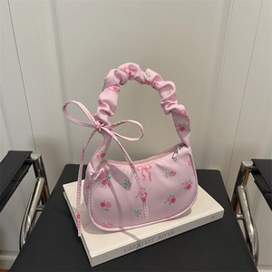 Floral print shoulder bag with pink roses, bow details, and a pleated cloud handle