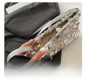 Close-up of smooth gold zipper and silver sequins on the stylish shoulder bag