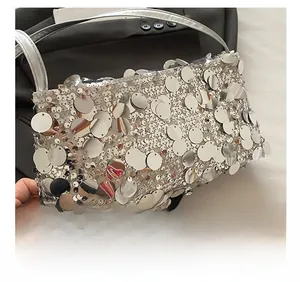 Detailed view of silver sequin handbag featuring premium fabric and metallic finish