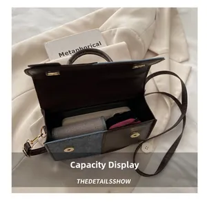 Detail view of the spacious inner compartment of the textured contrast crossbody bag