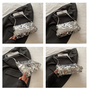 Close-up of silver sequined shoulder bag showing reflective texture and elegant strap