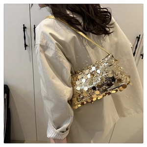 Detail of shimmering gold sequin shoulder bag showing the layered metallic texture