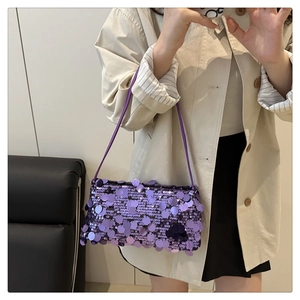 Detail of a purple sequined shoulder bag showing its texture and shiny reflective surface