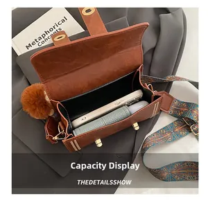 Internal view of retro brown crossbody bag showing capacity for phone and cosmetics