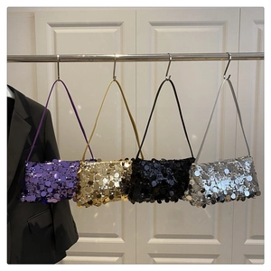 Close-up of four glittery sequin shoulder bags in purple, gold, black, and silver colors
