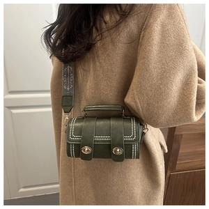 Detail of dark green cylinder Boston bag with silver studs and ethnic pattern strap