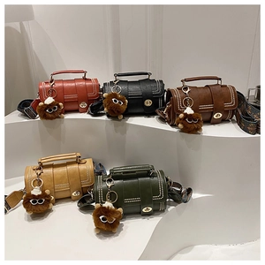 Detail of vintage cylindrical Boston bags in five colors with patterned wide straps
