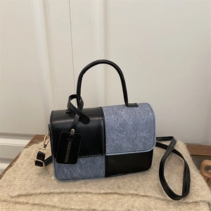 Minimalist square crossbody bag with black leather and blue denim color-block patchwork