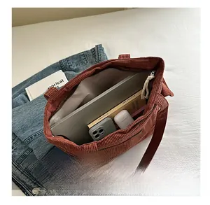 Brown corduroy tote bag interior view showing large capacity for books and tablet
