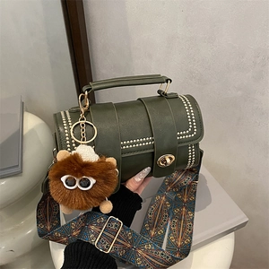 Green vintage cylinder Boston bag with gold studs and ethnic style wide strap