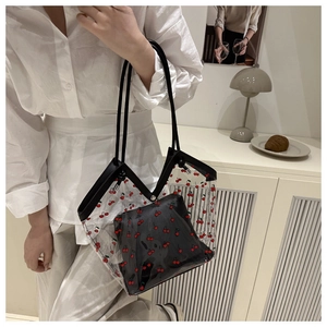 Detail view of transparent PVC cherry tote bag with independent black inner pouch