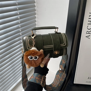 Vintage dark green hand-woven tote bag with gold rivets and colorful patterned shoulder strap