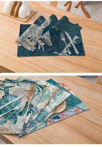 Macro detail of nautical sea turtle and starfish prints on thick linen fabric placemats