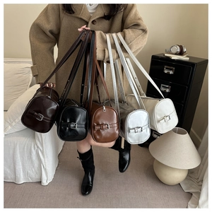 Group display of five stylish pillow bags in brown, black, silver, and cream colors