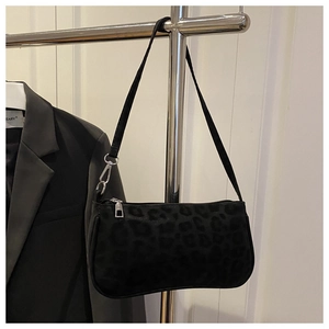 Close-up of black leopard print matte shoulder bag with silver zipper and slim strap
