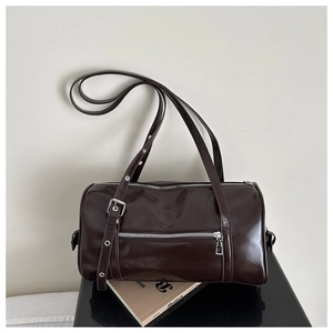 Detail of a dark brown polished leather Boston bag with silver zipper pocket