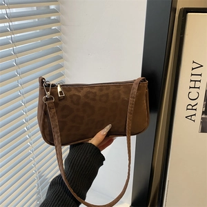 Brown leopard print baguette shoulder bag with matte texture and minimalist zipper design